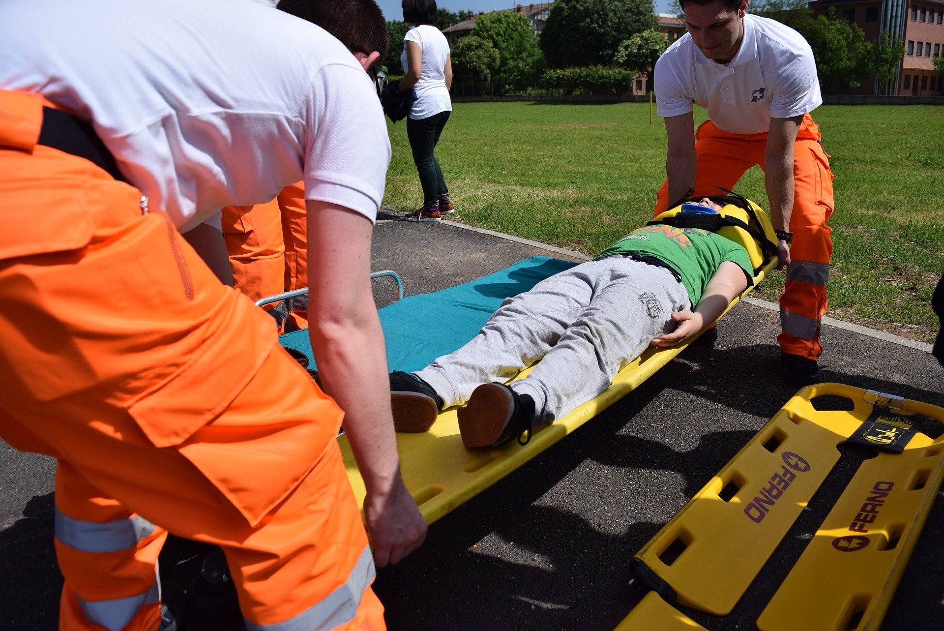 Paramedics placing an injured person onto a stretcher.